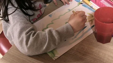 Child draws and paints a spring theme Stock Footage 99744930