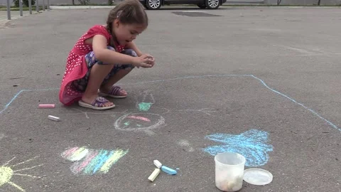 Child draws on the asphalt with crayons 2 Video stock 137657534