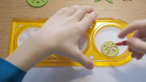 Child draws with ballpoint pen patterns using the graphical ruler Stock Footage 129401774