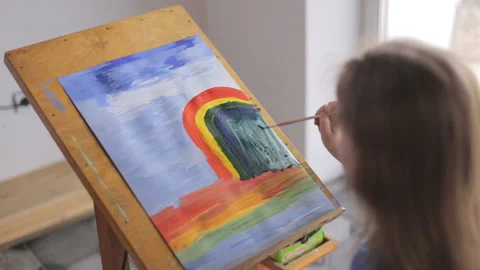 The child draws beautifully while sitting at the easel Stock-Footage 161719469