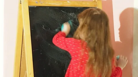 The child draws chalk on the Board Stock Footage 89243382