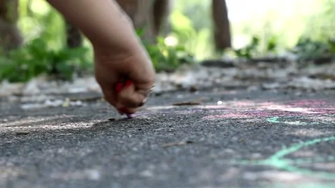 Child draws with chalk on the pavement Stock Footage 90985024