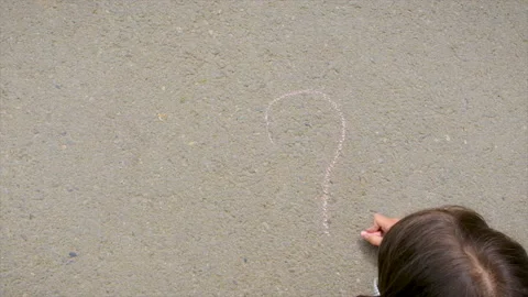 The child draws with chalk on the pavement. Selective focus. Stock Footage 230398388