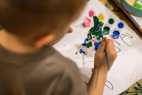A child draws an Easter bunny in different colors Stock Photos