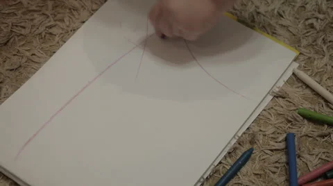 Child draws enthusiastically on notepad Video stock 42320451