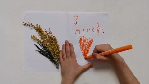 A child draws a greeting card for March 8 스톡 동영상 205871655