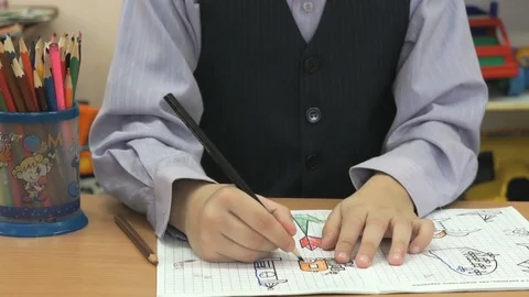 Child draws the images in notebook using pencils Stock Footage 71107080
