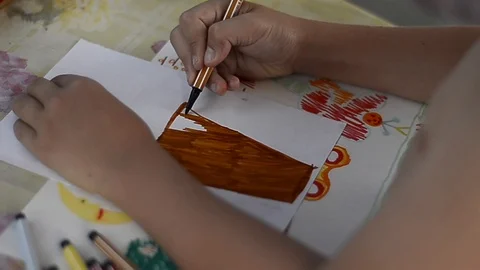 Child draws on a leaf Stock Footage 88957765