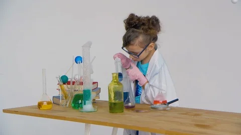 The child draws a liquid into the syringe Stock Footage 90098571