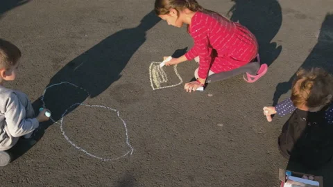The child draws with melrom on the pavement. Selective focus. Stock Footage 196742405