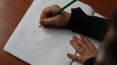 A child draws on the paper Stock Footage 130268217