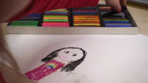 The child draws pens with colored crayons Video stock 169694091