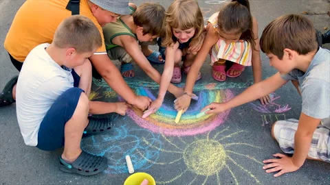 The child draws a rainbow with chalk. Selective focus. Stock Footage 157382525