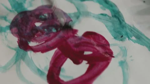 Child draws with red paint on a white paper. Stock Footage 130881449