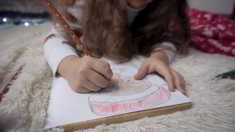 The child draws Santa Claus with different pencils Stock Footage 120706003