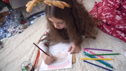 The child draws Santa Claus with different pencils Stock Footage 120706086
