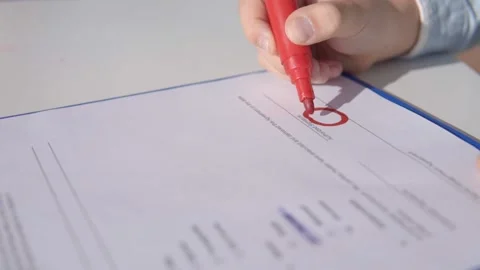 Child draws a smiley and scribbles with a red marker Stock Footage 145629088
