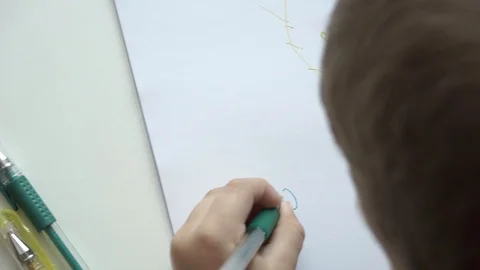 Child draws on a white sheet of paper Stock Footage 114708085