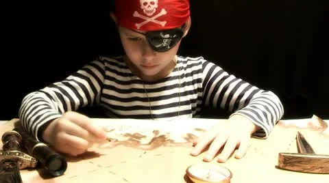 Child dressed as a pirate treasure map drawing Stock Footage 12689561