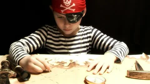 Child dressed as a pirate treasure map drawing Stock Footage 12689567