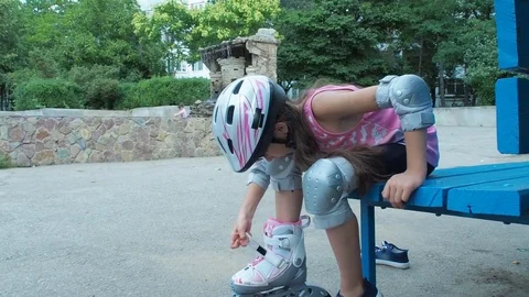 Child dresses roller skates. Stock Footage 77799867