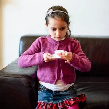 Child is drinking from the cup Stock Photos