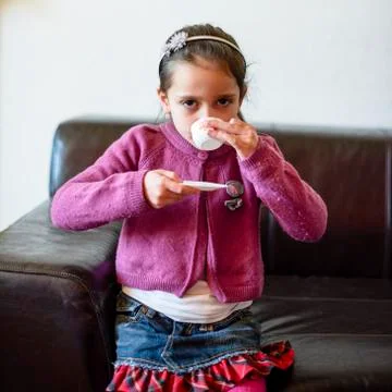 Child is drinking from the cup Stock Photos