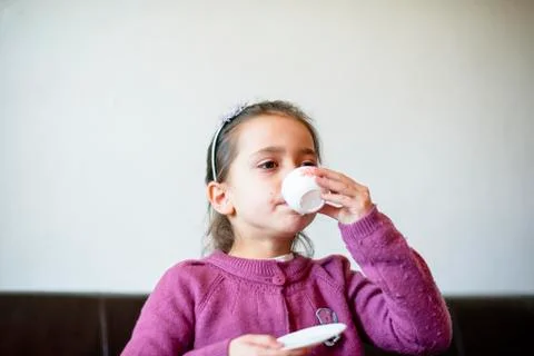 Child is drinking from the cup Stock Photos