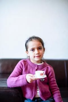 Child is drinking from the cup Stock Photos