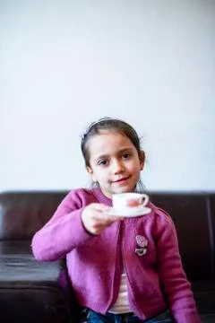 Child is drinking from the cup Stock Photos
