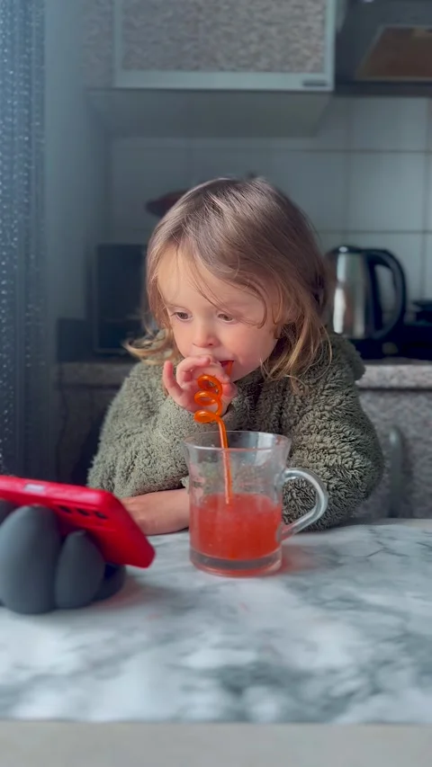 Child Drinking Juice with Straw at Table Indoor Scene Stock-Footage 333149618