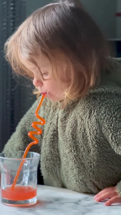 Child Drinking Juice at Table Indoor Close Up Видео 333149613