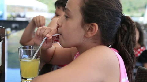 Child drinking lemonade at the restaurant 3 Stock Footage 63324800