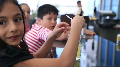 Child drinking lemonade at the restaurant 4 Stock Footage 63324965