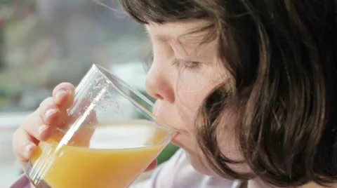 Child drinking orange juice 스톡 동영상 12529128