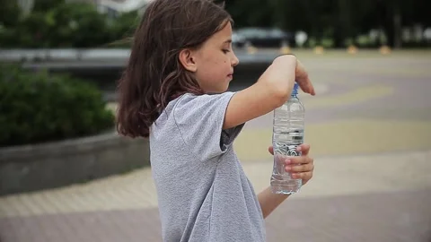 Child drinking water from bottle Stock Footage 166154747