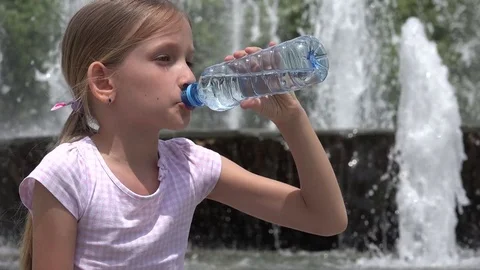 Teen girl drinking water from bottle in summer park. Drinking water in the  heat concept. Close-up Stock Video Footage by ©lizaelesina #489034632