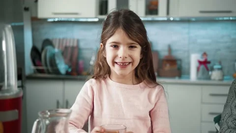 Child drinks freshly squeezed juice at his grandmother. Stock Footage 168827512