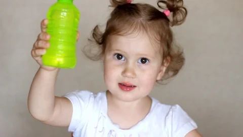 A child drinks juice from a bottle. Stock Footage 78058689