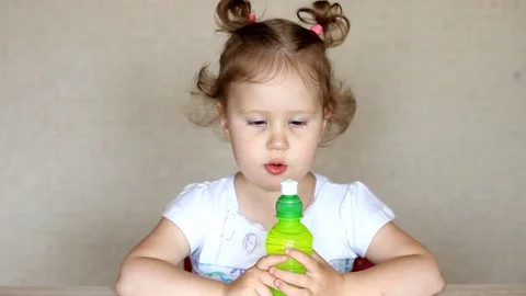 A child drinks lemonade from a bottle. Stock Footage 78058469