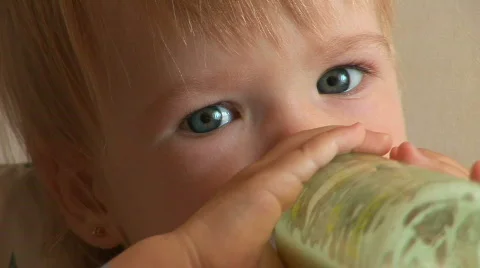 Child drinks milk from a bottle. Stock Footage 546955