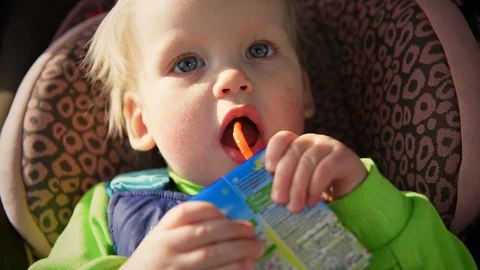 A child drinks from a straw juice closeup Stock Footage 87442674