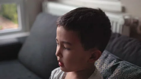 A child drinks syrup from a spoon given to him by his mother Stock Footage 202072540