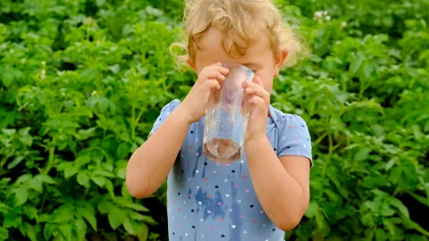 A child drinks water in the garden. selective focus. Stock Footage 270918217