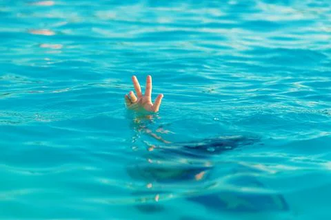 The child is drowning in water. Selective focus. Stock Photos