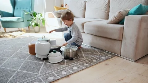 Child drummer having fun drum playing on kitchen pans at home Stock Footage 202104873