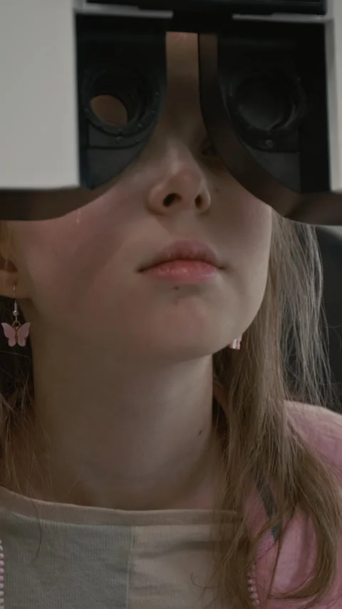 Child During Eye Exam with Machine in Ophthalmology Clinic Vertical Stock Footage 322779548