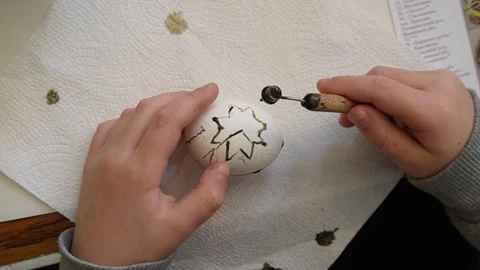 A child dying Easter egg with with Wax and Dye method Stock Footage 268640081