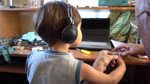 Child in earphones learning the morse code Stock Footage 84792475