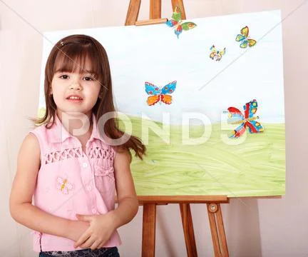 Child with easel in preschool. Stock Photos
